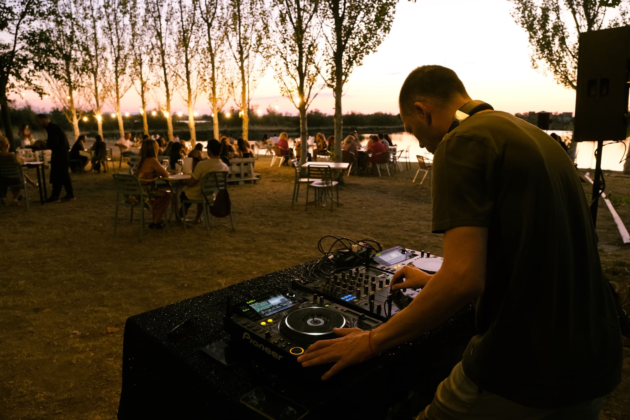 A DJ performing at an outdoor gathering